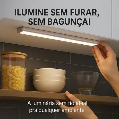 Luminária de LED sem fio instalada sob armário de cozinha iluminando bancada.